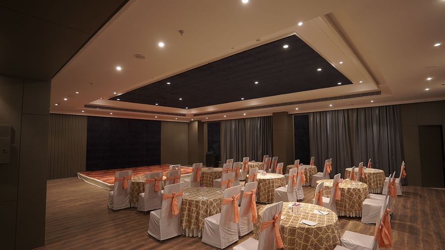 banquet hall with round tables and chairs at Classic Sapphire by Ananta