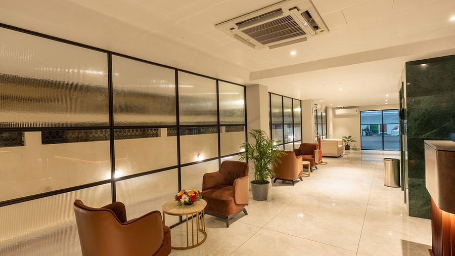 A reception area with comfortable chairs and great lighting - Court 11, Kochi