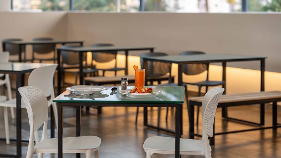 A close up view of our restaurant with comfortable chairs and tables - Court 11, Kochi