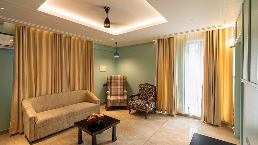 Another view of a living area with comfotable sofa and a chair in Suite room - Court 11, Kochi