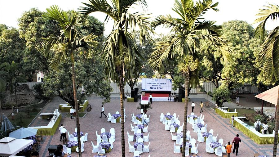 Damanganga Valley Resorts Pvt Ltd - an aerial view of a seating arrangement in the courtyard during daytime