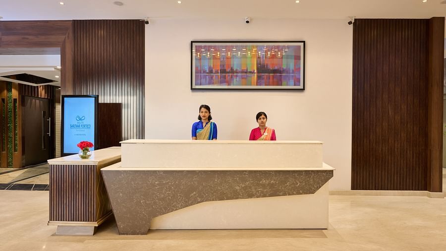 An image of the hotel reception with two women standing behind the counter