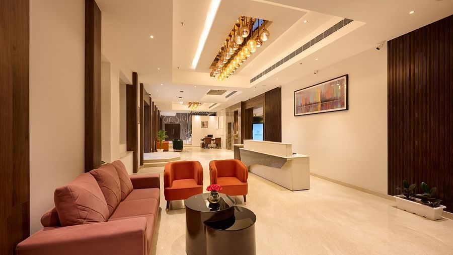 An image of the hotel lobby with comfy sofas and a reception desk