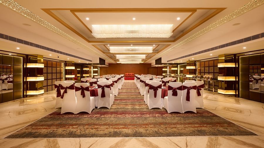 A large banquet hall with chairs arranged in a class room type seating