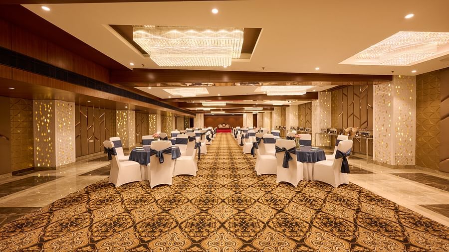 A banquet hall at our hotel with chairs and carpeted flooring