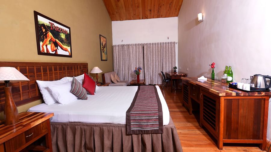 room with a king size bed and wooden interiors at destiny the farm resort