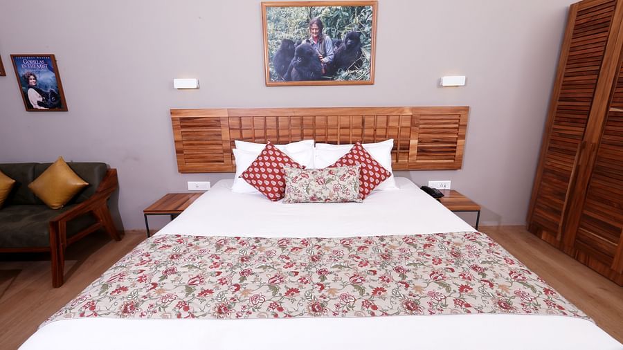 room with a king size bed and wooden interiors at destiny the farm resort
