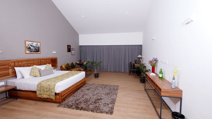 room with a king size bed and wooden interiors at destiny the farm resort