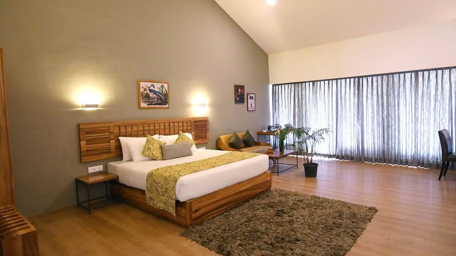room with a king size bed and wooden interiors at destiny the farm resort