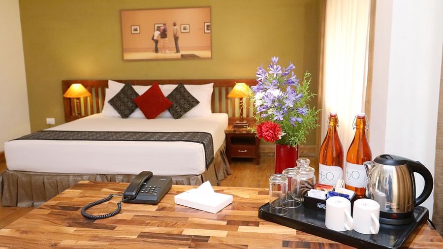 room with a king size bed and in-room amenities at destiny the farm resort