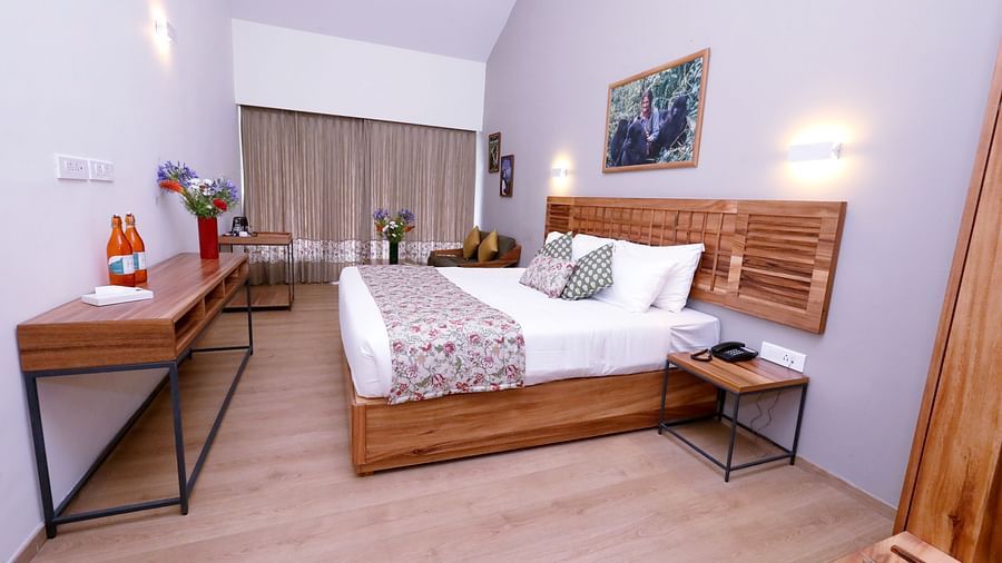 room with a king size bed and wooden interiors at destiny the farm resort