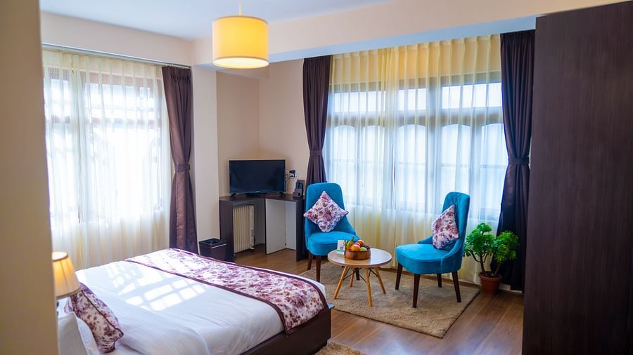 Dream Villa Retreat, Pelling - Interiors of the Premium Rooms with two bluw chairs and a coffee table made into a sitting area