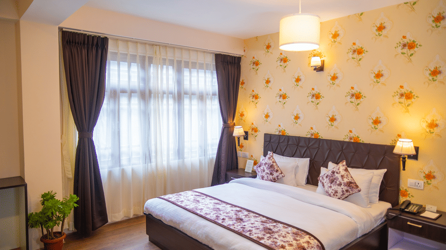Dream Villa Retreat, Pelling - The king size bedding placed next to the decorated wall in the bedroom