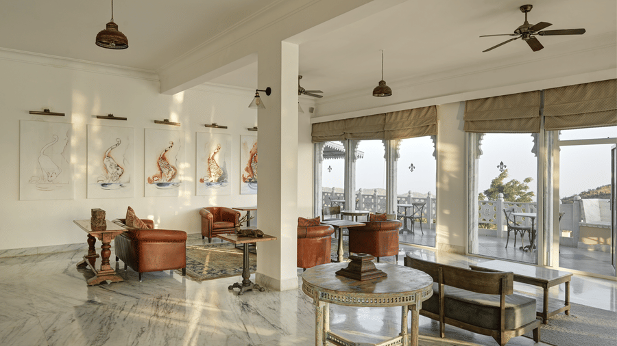 Seating area at Fateh Safari Suites featuring sofa set with centre table and other decorative elements.