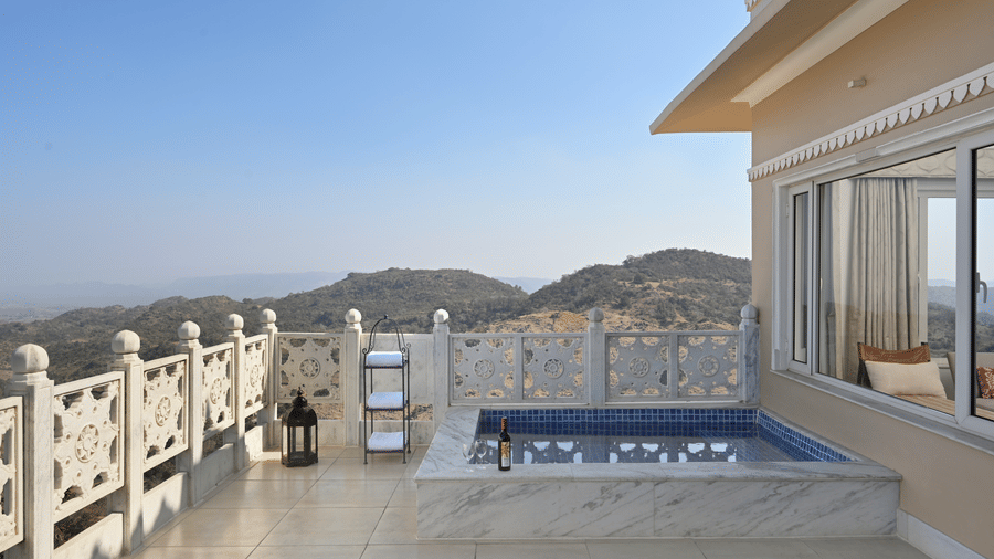 Balcony of Plunge Pool Suite in Fateh Safari Suites featuring a small pool beside a room which provides a valley view. 