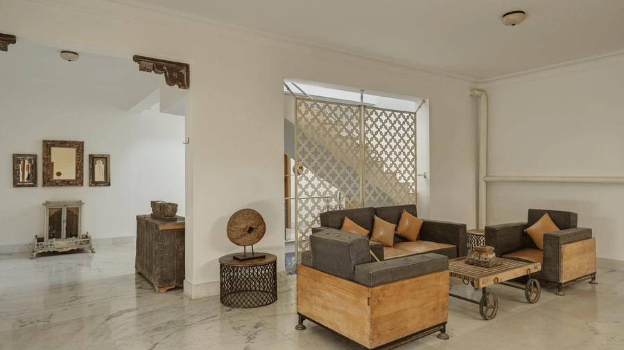 Seating area at Fateh Safari Suites featuring sofa set with centre table and other decorative elements.