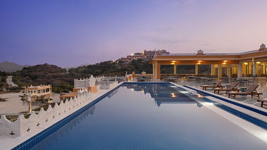 Fateh Vilas Udaipur - view of the property's swimming pool at sundown