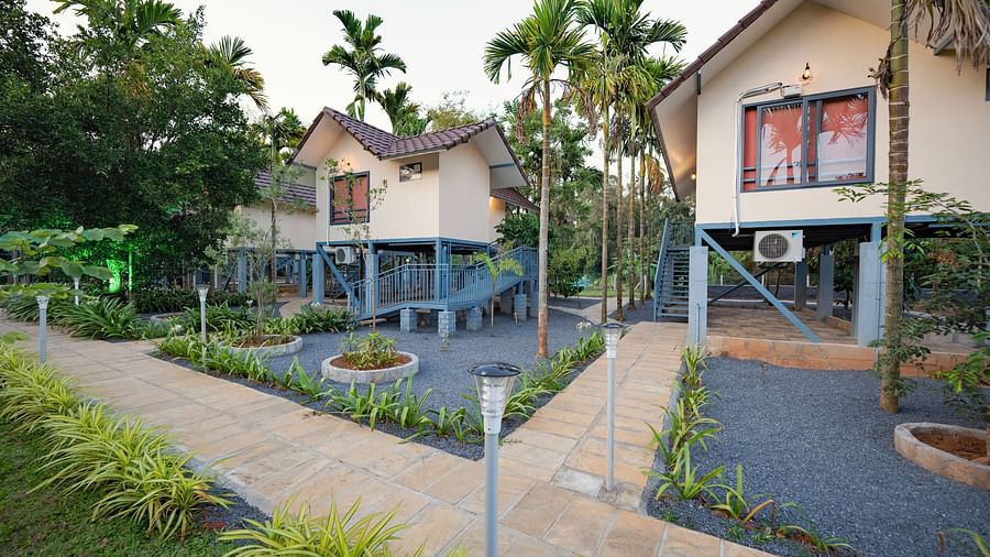 Facade of accommodations with small garden in front at Feel Free Retreat, Wayanad