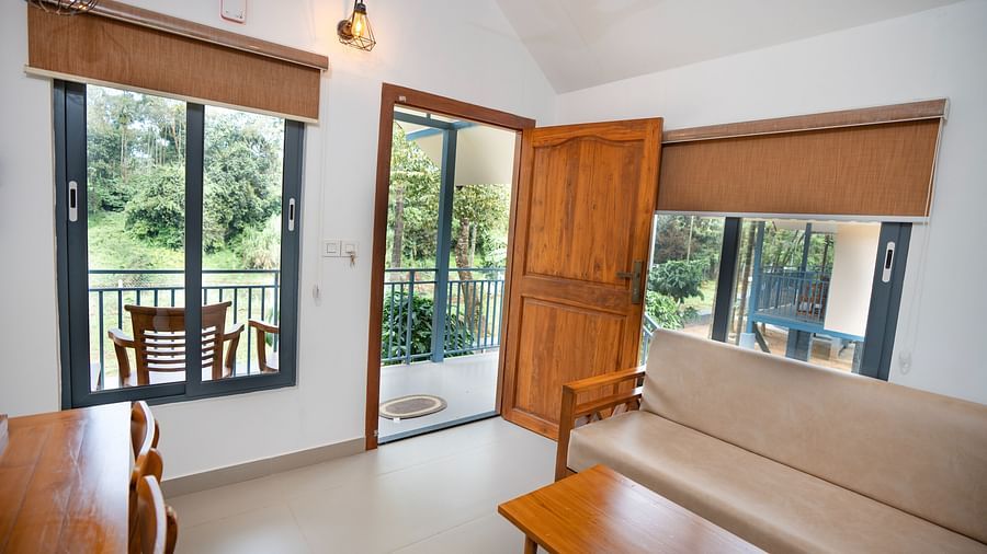 Sitting area with sofa and wooden table at Feel Free Retreat, Wayanad