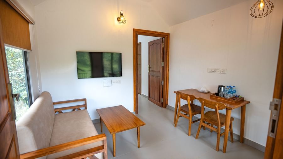 Sitting area with wooden furnishings at Feel Free Retreat, Wayanad