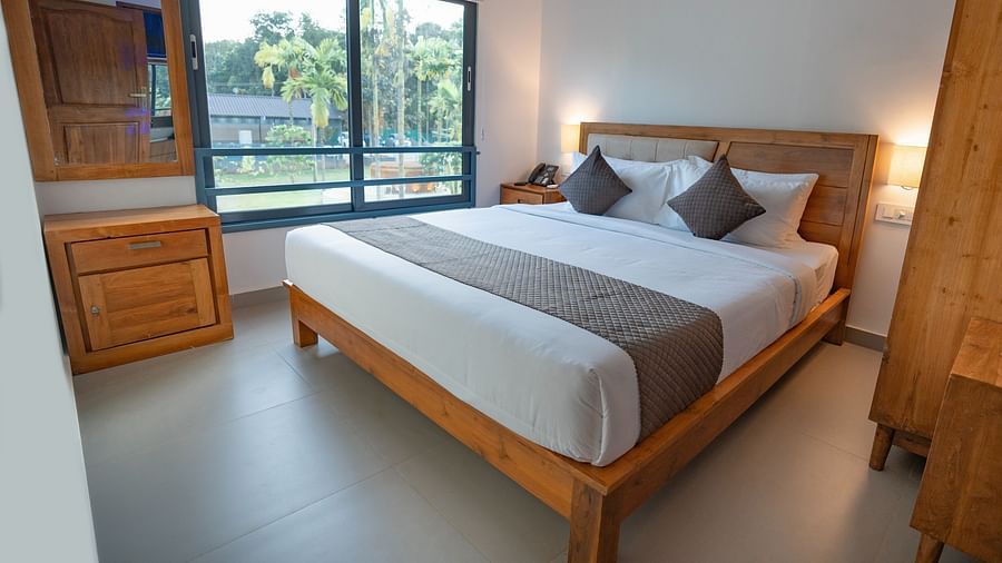 Room with wooden furnishings and bed at Feel Free Retreat, Wayanad