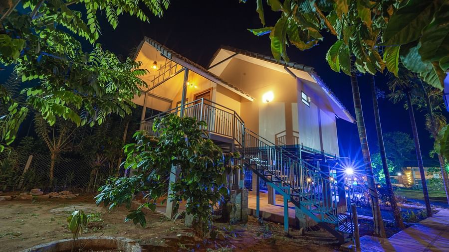 A property surrounded by tress at night at Feel Free Retreat, Wayanad