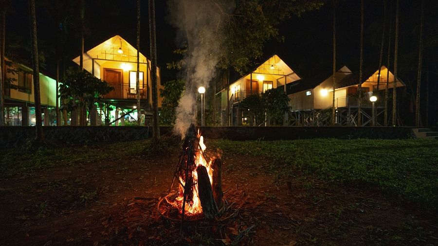 Night view of the property with a bonfire in front at Feel Free Retreat, Wayanad