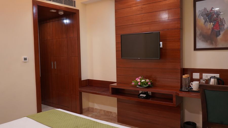 An image of a bedroom which also features a flat TV screen, a work desk an dchair, a tea and coffee maker, and other elements at Five Elements Hotel, Jodhpur