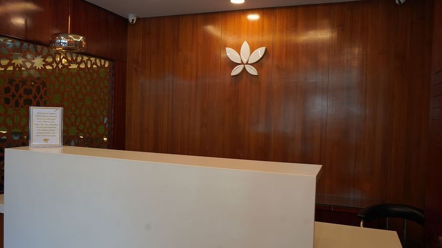 An image of a reception lobby featuring a huge desk and a flower symbol behind the wall at Five Elements Hotel, Jodhpur