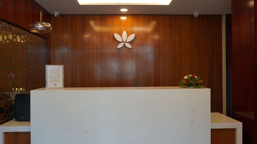 An image of a reception desk where a welcome note is placed along with a small bouquet at Five Elements Hotel, Jodhpur