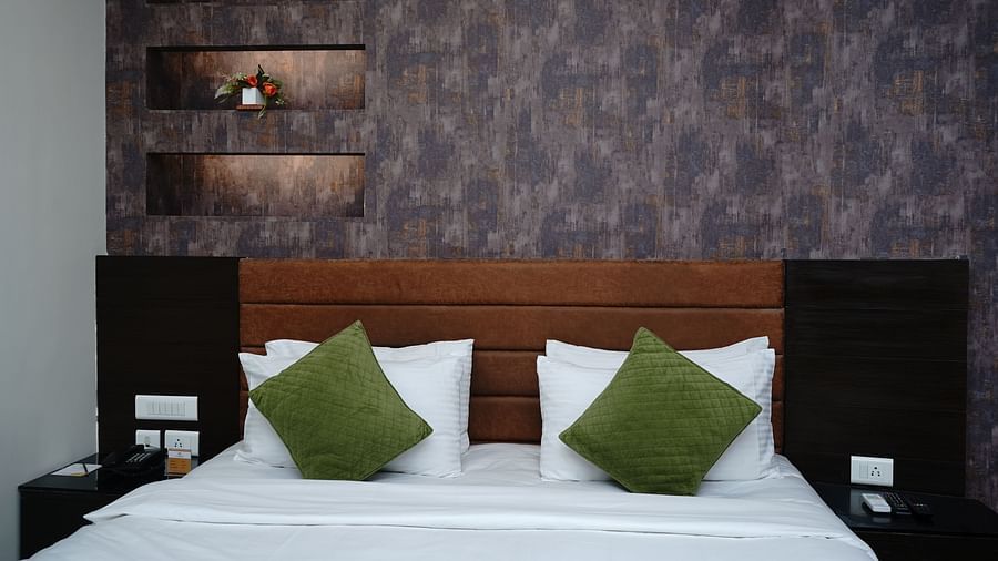 An image of a bedroom featuring a double size bed and bedside table on each side at Five Elements Hotels North Avenue, Delhi