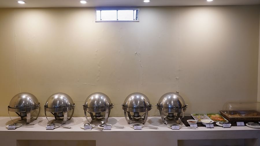 An image of a buffet area featuring several pots where food is kept in a restaurant at Five Elements Hotels North Avenue, Delhi