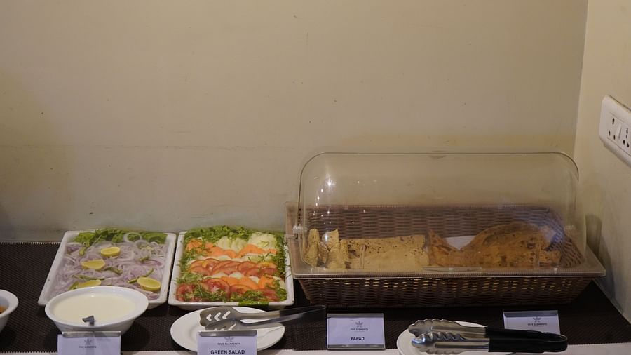 An image of buffet area featuring vegetable salads and breads at the restaurant of Five Elements Hotels North Avenue, Delhi