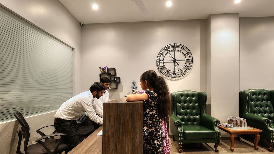 Staff members behind the desk inside the Reception - Magnus Fortune House, Magarpatta