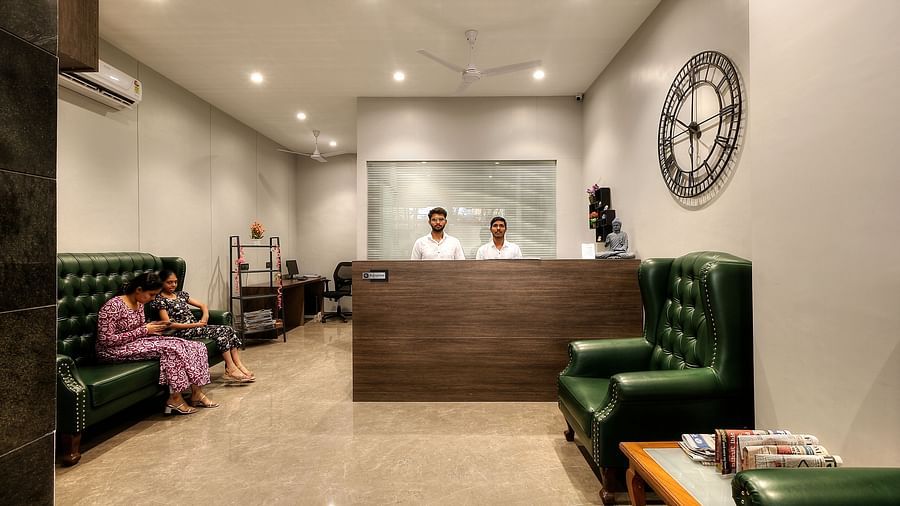 front view of the Reception with a large clock next to the desk - Magnus Fortune House, Magarpatta
