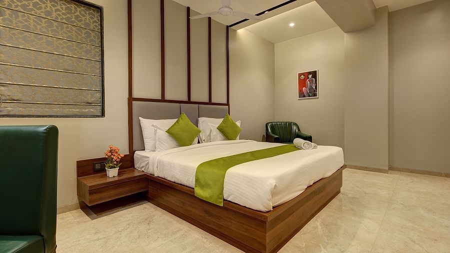 A double bed with side tables inside Luxury Suite - Fortune House, Magarpatta