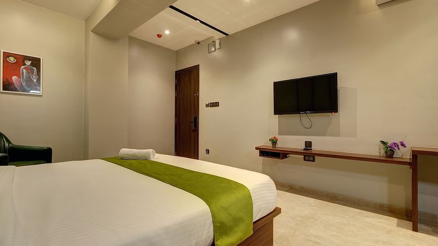 Side view of the double bed inside Luxury Suite - Fortune House, Magarpatta