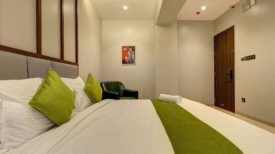 A close up shot of a double bed inside Luxury Suite - Fortune House, Magarpatta