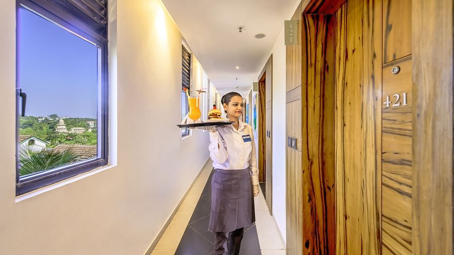 Hotel staff member standing in corridor near room 421 - Golden Tulip, Candolim, Goa