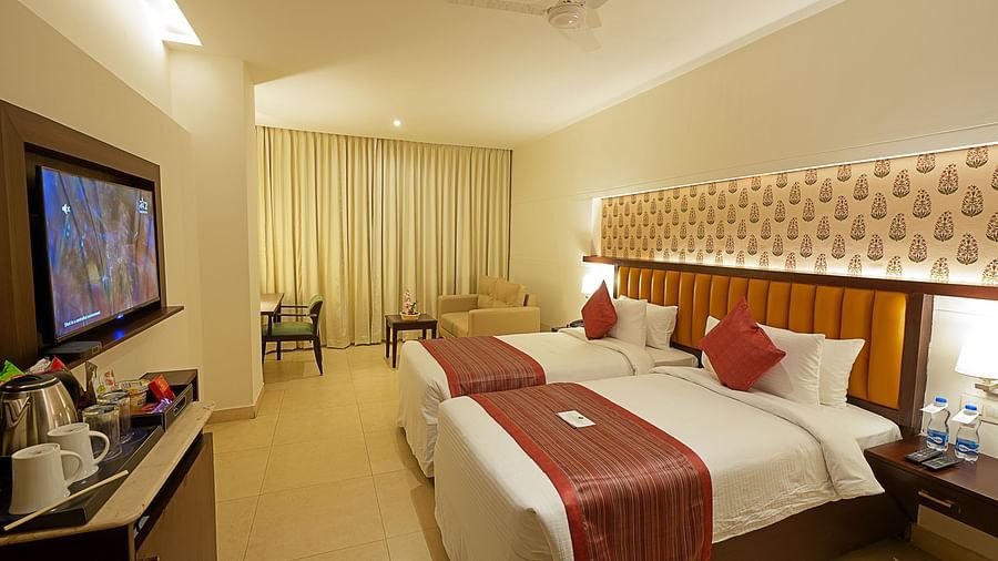 Deluxe room at Grand Continent, Secunderabad with twin beds and a television