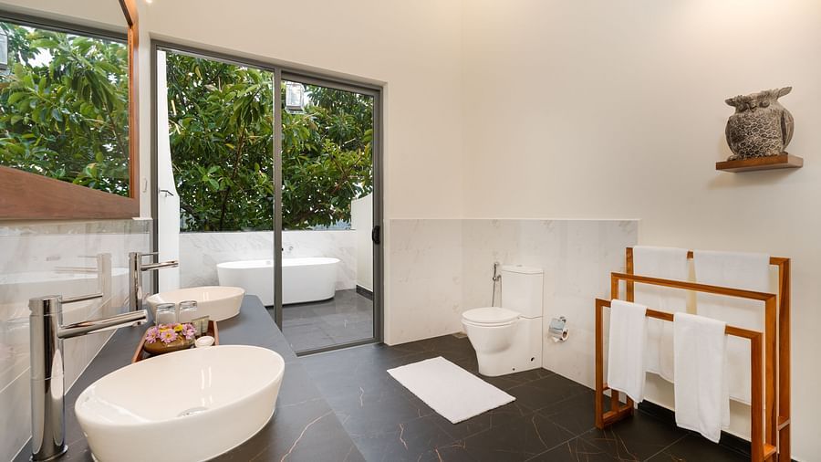  A bright and airy bathroom featuring a freestanding bathtub, large windows, and contemporary fittings - Heavensa Villas and Suites by the Clarks, Galle