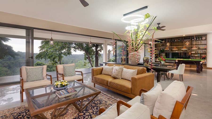 A modern living room with comfortable furniture, stylish decor, and large windows allowing plenty of natural light and views of the surrounding landscape - Heavensa Villas and Suites by the Clarks, Galle