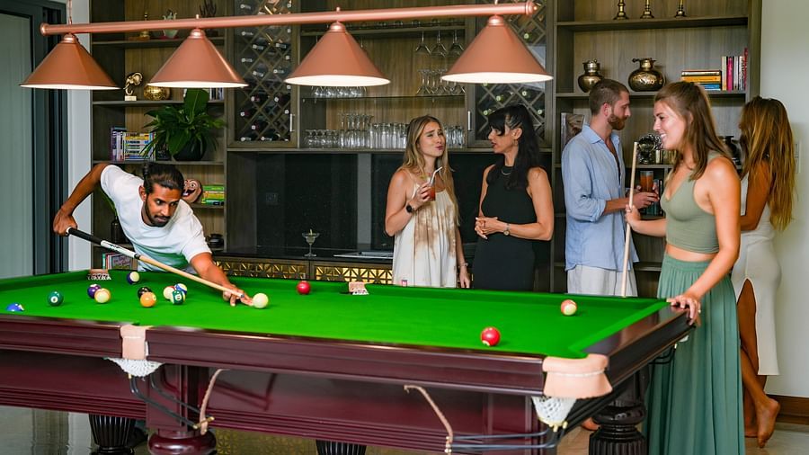  A vibrant pool table in use, with a group of people enjoying a game of billiards in a spacious, warmly lit lounge area - Heavensa Villas and Suites by the Clarks, Galle