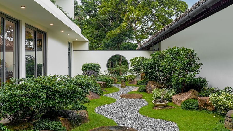 A beautiful garden path surrounded by greenery and decorative plants, leading to a serene outdoor space with a peaceful atmosphere - Heavensa Villas and Suites by the Clarks, Galle