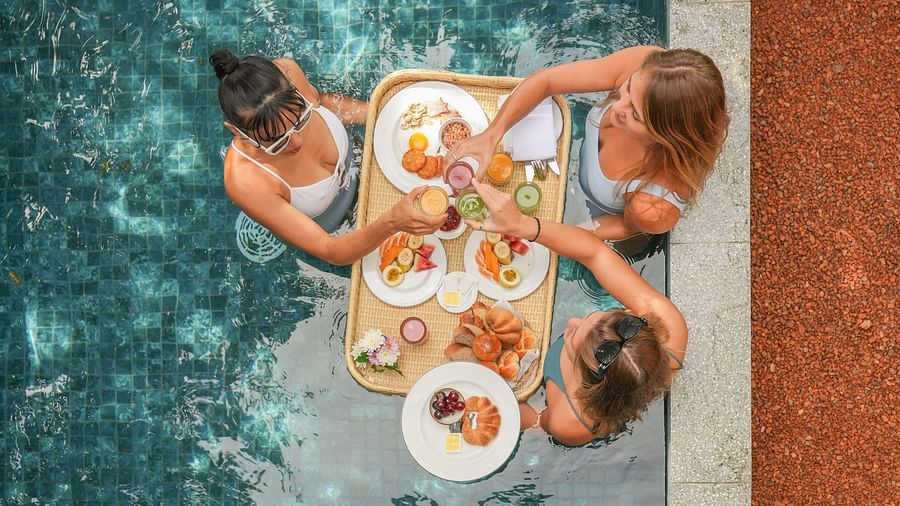  A unique dining experience featuring a floating breakfast tray in a private pool, enjoyed by two guests - Suite with Private Pool at Heavensa Villas and Suites by the Clarks, Galle