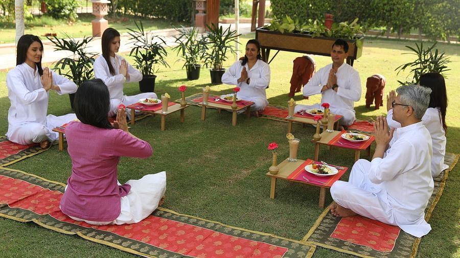 a group of people doing yoga in the lawn