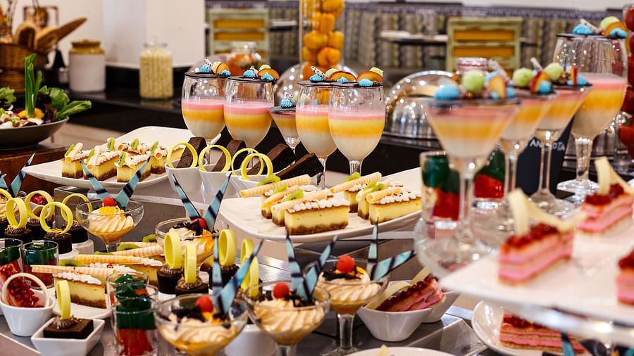 an assortment of dishes and desserts at chutney - restaurant near arossim beach in goa at Heritage Village Resorts and spa