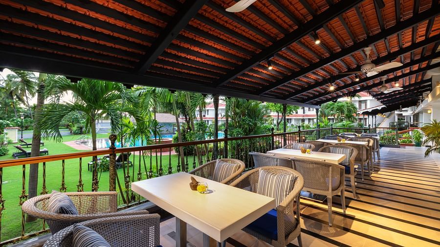 outdoor seating space overlooking the lush green gardens at chutney restaurant in south goa