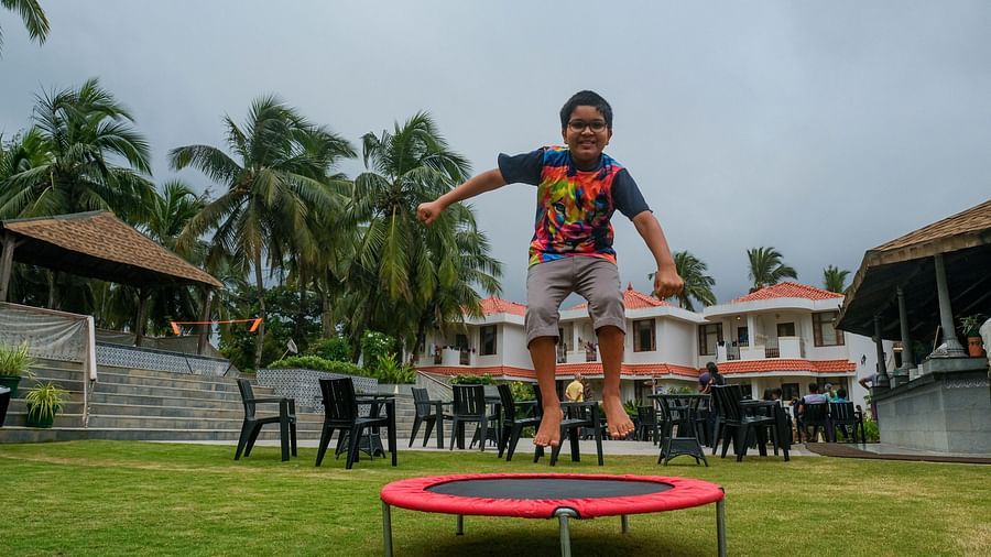 a boy jumping on the trampoline