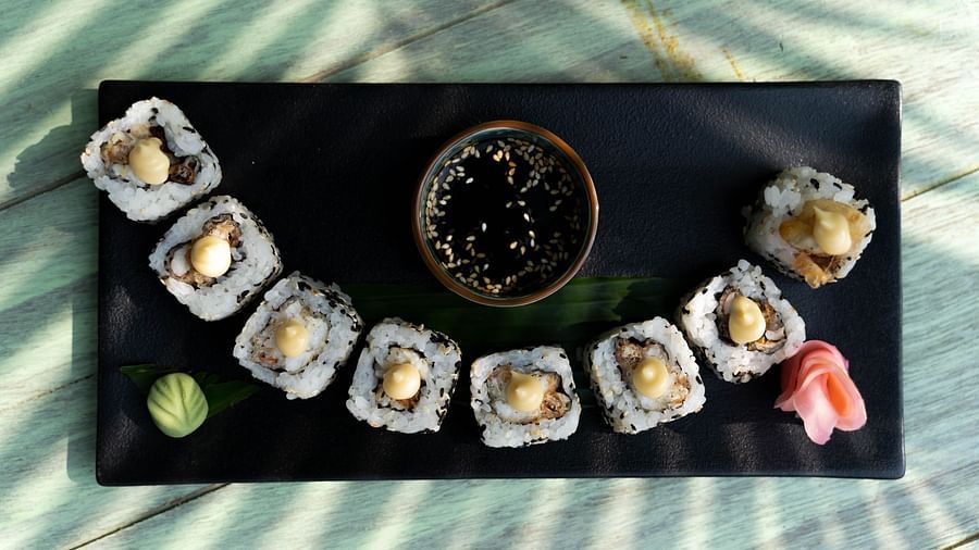 a plate of sushi and dip